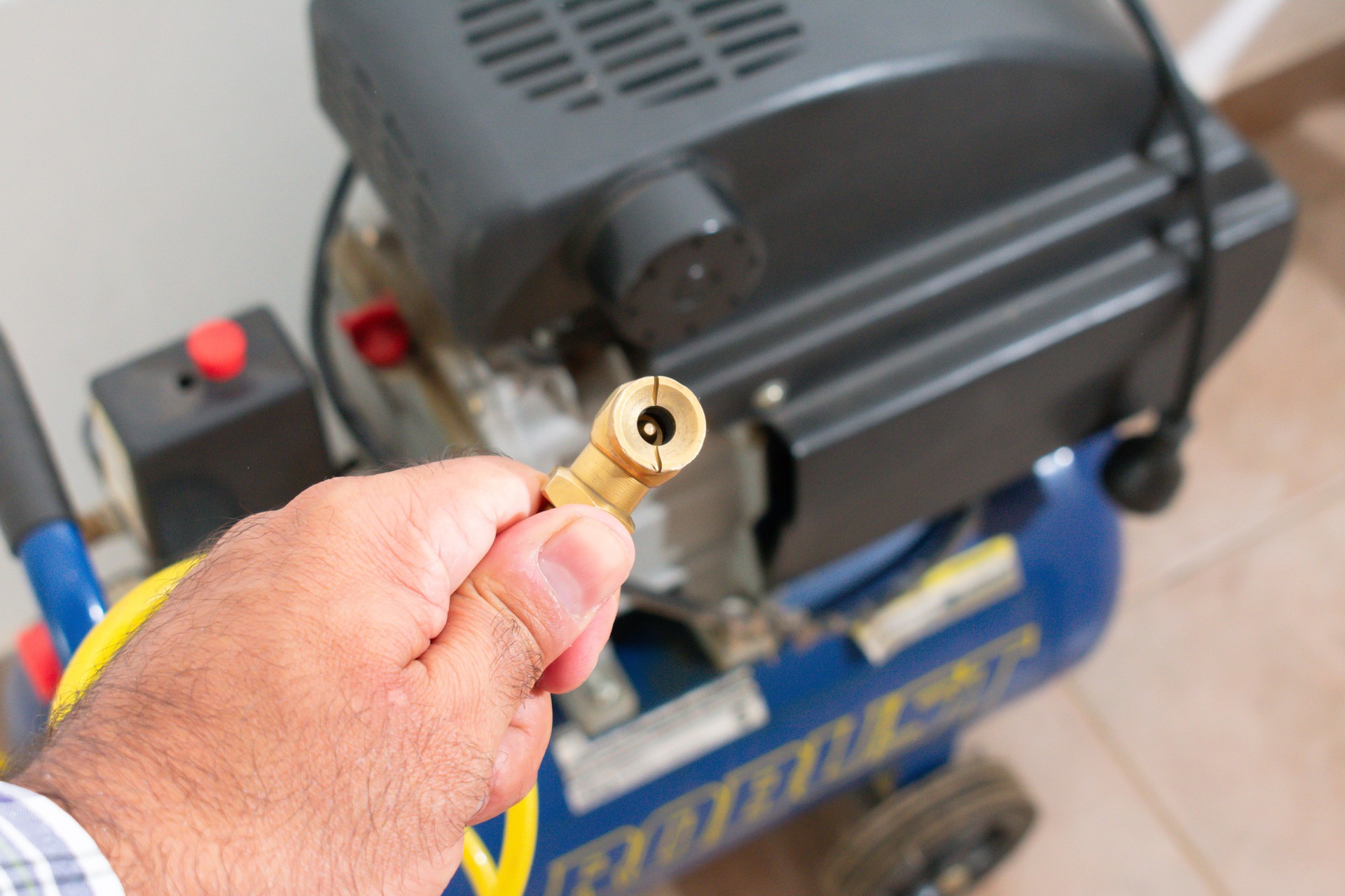 Air Compressor Power: A Man Holding Tire Inflator Nozzle